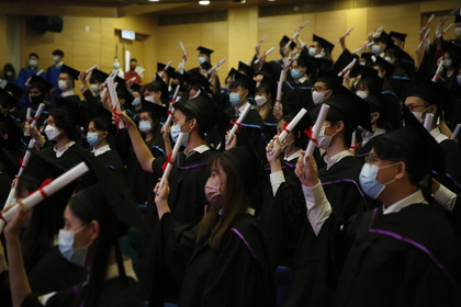  Fellow graduates at in-person Commencement celebrate their accomplishment